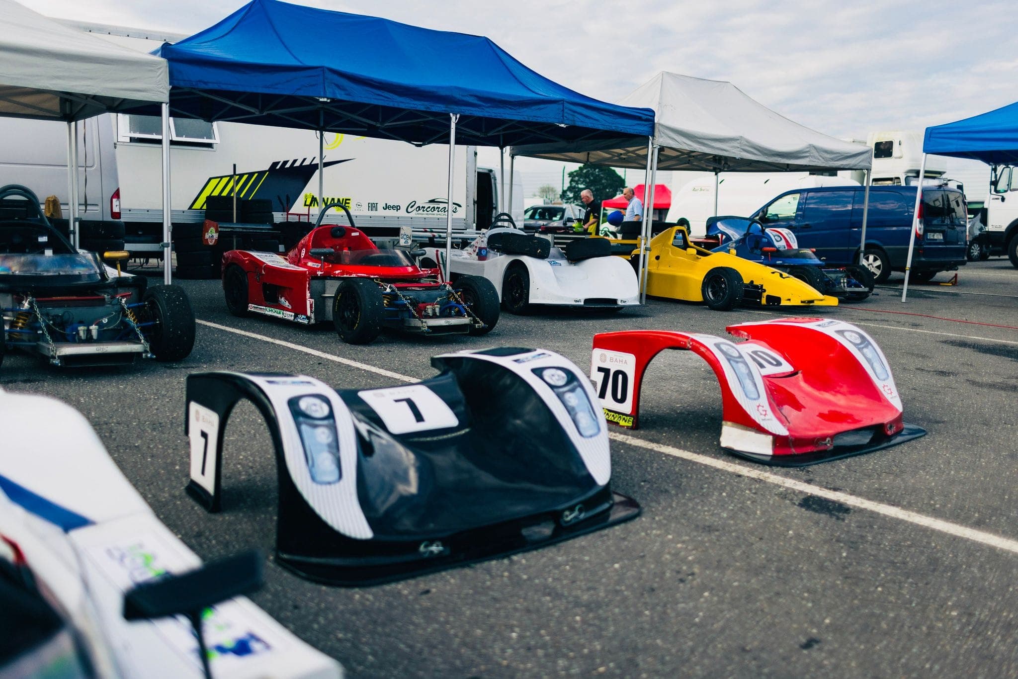 Global Lights cars and bodywork lined up in the race-day paddock