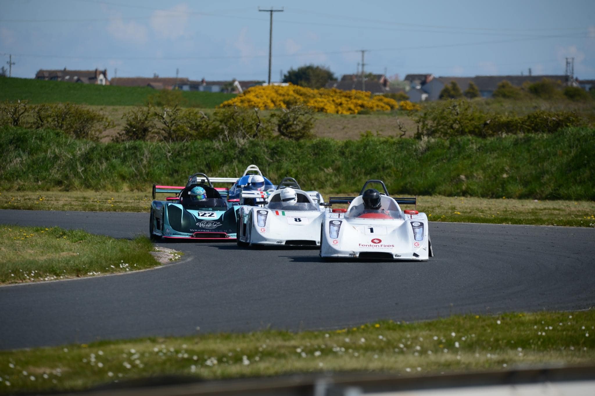 Race cars navigating a turn on the track