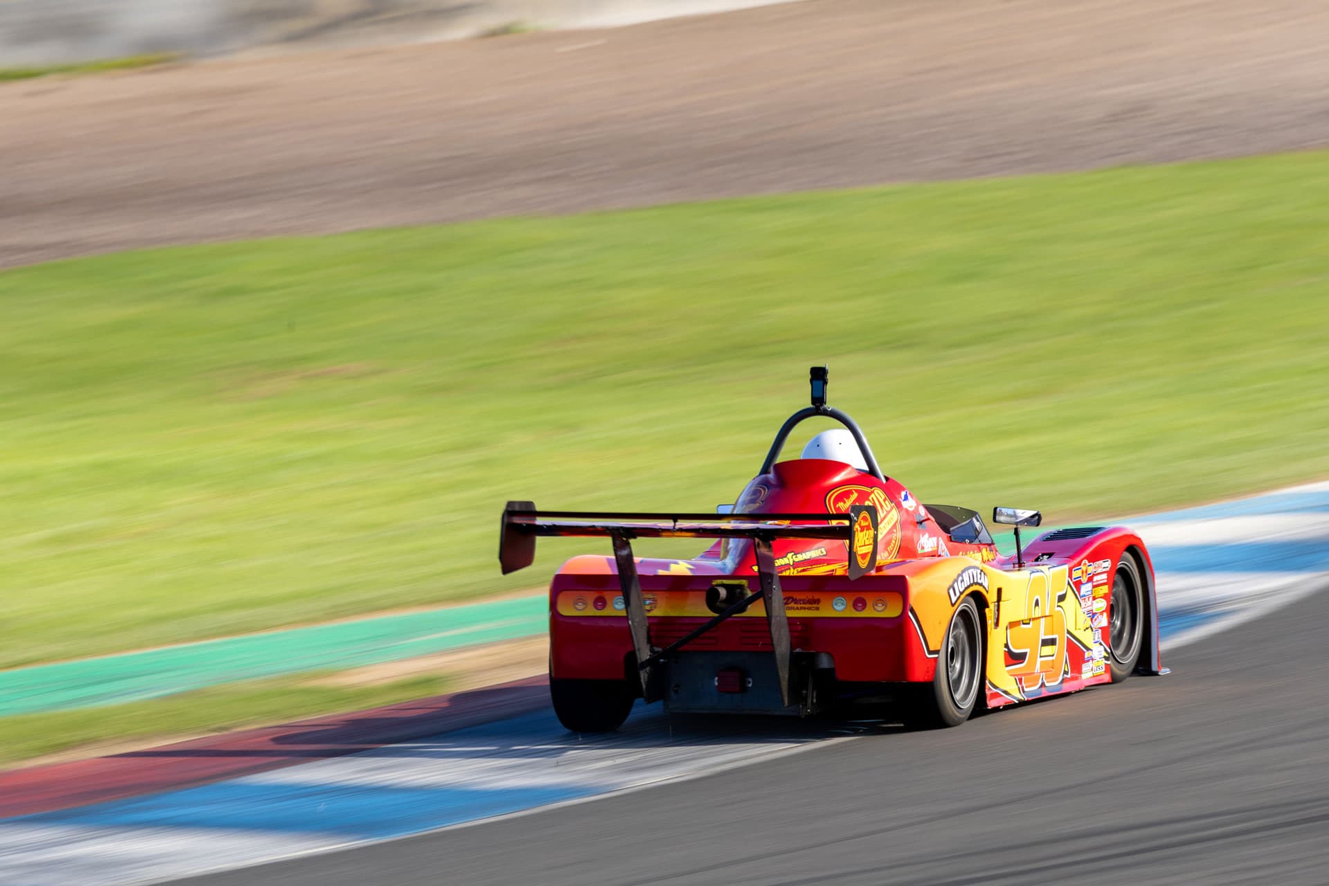 Cars leaning through the twilight at the track